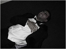 David writhes around on the floor in pain